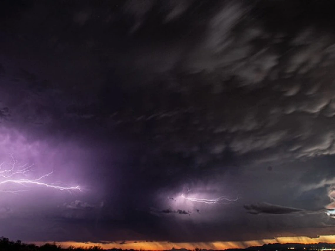 Clouds and lightning over a desert landscape