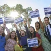 six students holding up signs with their medical residency placements written on them