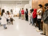 students standing and watching a presentation in an engineering lab